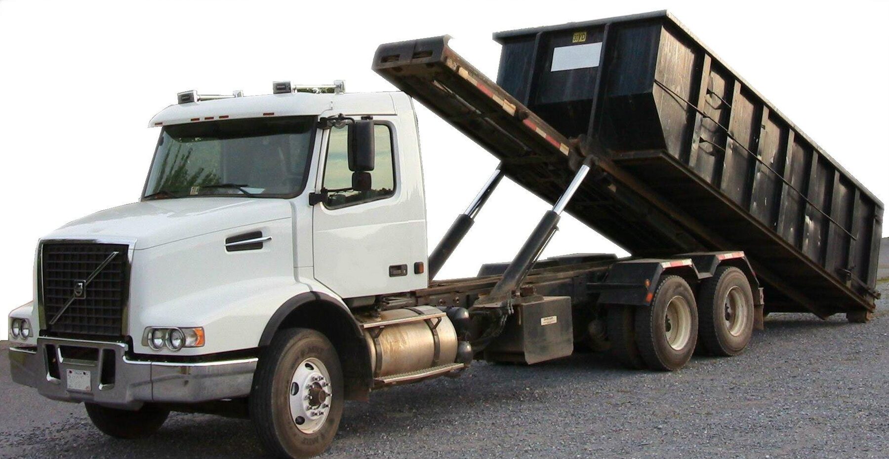 Roll-off truck setting down an empty container for a free scrap metal pickup